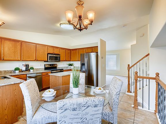 when you walk in the front door, the living room is immediately to the right (in the distance beyond the stair-rails) - the upwards railing goes to the 3 bedrooms - the downward one goes to the great room - this is a nice kitchen with a breakfast nook