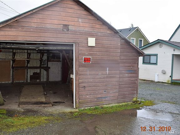 1 car garage with power and automatic garage door opener.  There is even a mechanics pit. Possible to retain a wall and remodel??