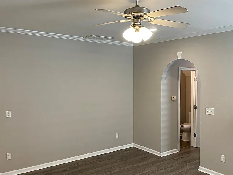 DEN WITH VIEW OF 1/2 BATH IN HALLWAY.