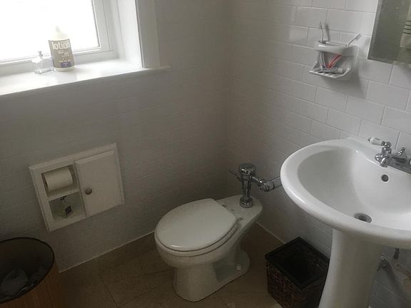 Bathroom features brand new subway tiles, paint, and NEW tem