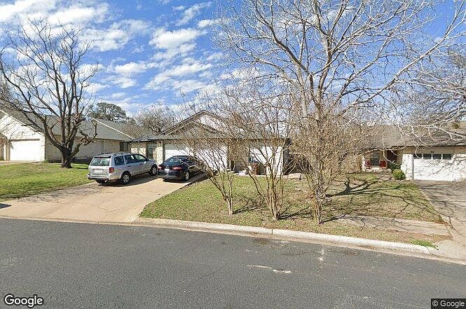 Street View. Ample amount of parking for two cars on the driveway. Plus additional attached parking garage with new garage door opener.