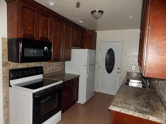 Kitchen, appliances include, stove, microwave, refrigerator, garbage disposal, dishwasher.