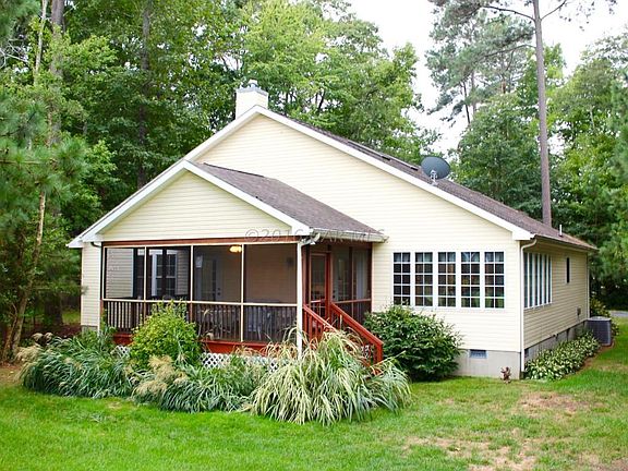 Back of home with screened porch