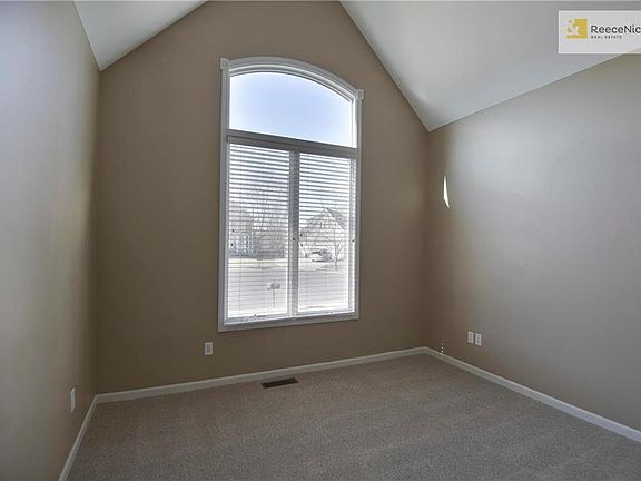 Main floor office w/ vaulted ceiling and new carpet.