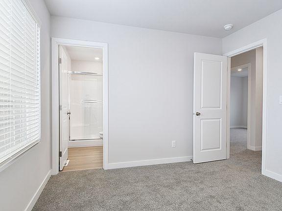 The master bedroom is spacious with a large window.