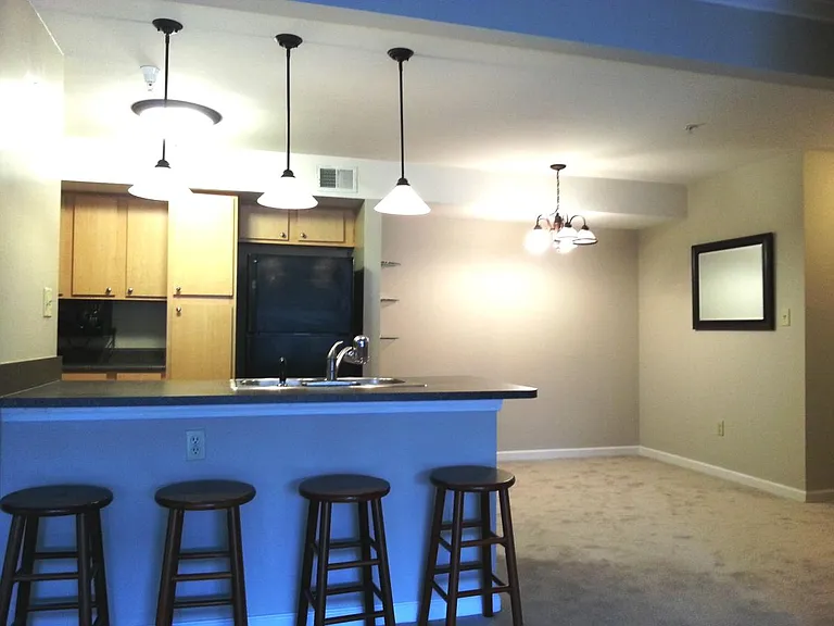 Chandelier and lots of lights in open kitchen-dining area