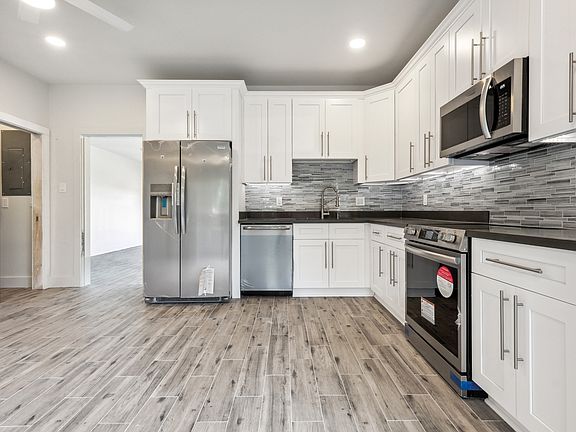 Kitchen area with door leading in to large front bedroom.