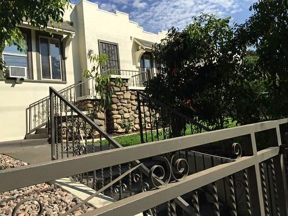 front of house w/ mango tree & gated entry