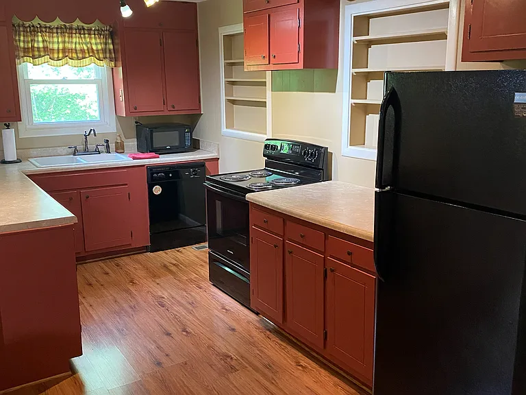 (1 of 2) Updated kitchen with lots of cabinet space and built in shelving/pantry.
