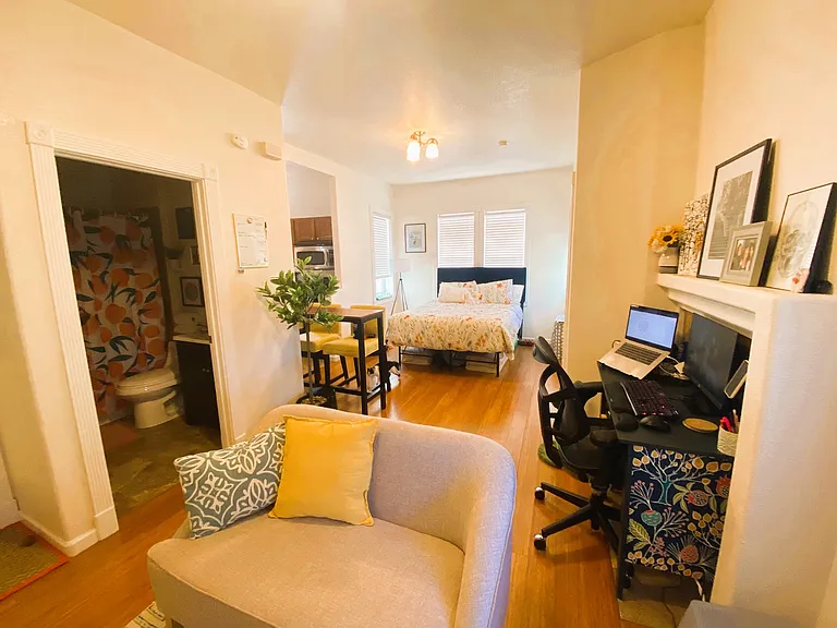 Spacious main living area filled with historic character and beautiful natural light. Separated from kitchen area.