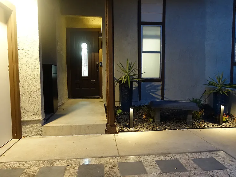 Front Entrance at night: Landscaped area with pathway lights. Exterior light over garage door