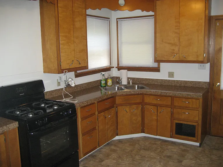 Old fashion style kitchen with coffee grinder and a new gas stove.