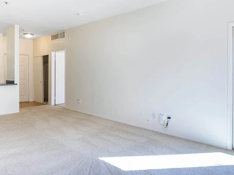 Carpeted Living Room with Balcony