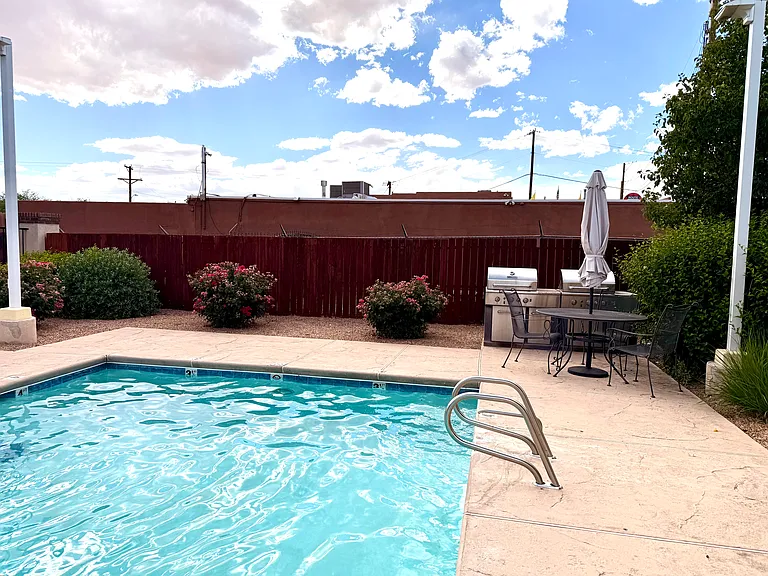 BBQ grills located adjacent to the pool area, perfect for outdoor gatherings