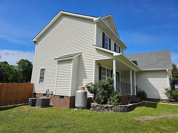 Two hvac units (one for each floor) and a propane tank for the gas fireplace