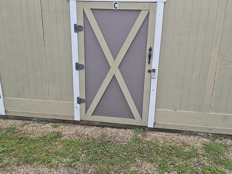 Outside storage unit with door closed.