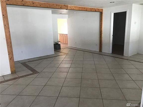 Living room looking from front door looking toward kitchen and dining area.