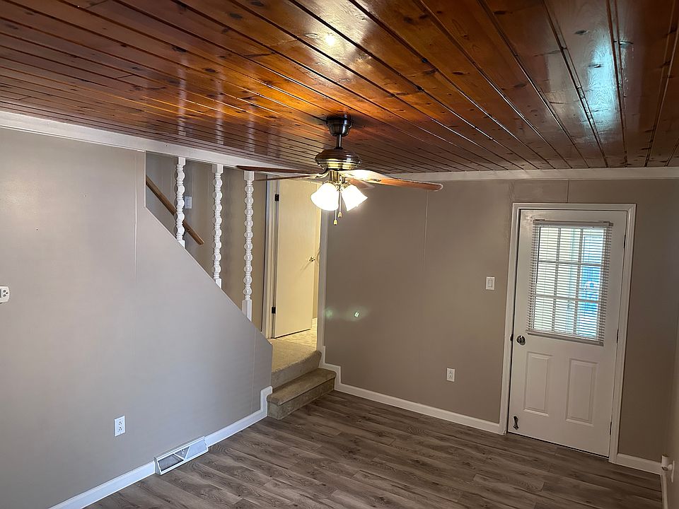 Dinning Room to kitchen and mud room and two steps to bathroom. The mud room leads to a large porch. Pine ceilings, new paint, flooring, trim and outlets.