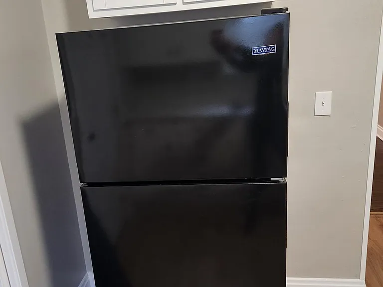 New refrigerator with extra cabinet storage above, new luxury vinyl floor