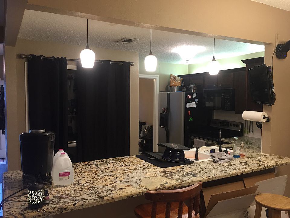 Granite open concept kitchen. Washer dryer behind drapes. Now there are folding doors.