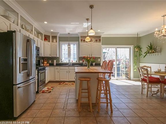 Bright and spacious kitchen. Corian countertops and butcher block island.