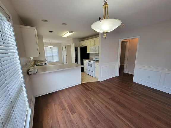 Dining room & kitchen beyond.