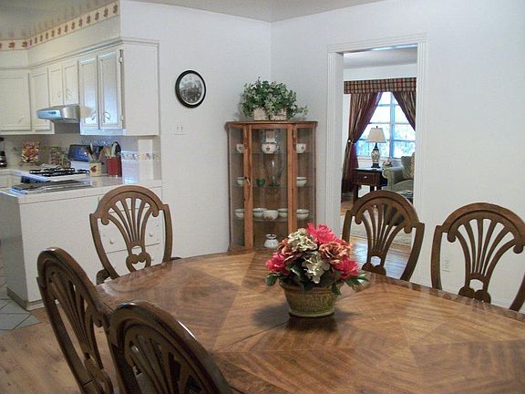 Dining area looking into kitchen and living areas