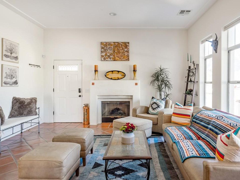 beautiful living room with vaulted ceilings, fireplace and bright lighting
