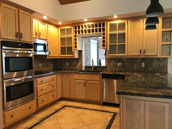 Open kitchen with peek-a-boo window to Florida room
