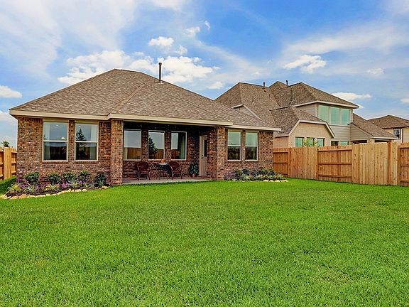 Covered patio with spacious yard