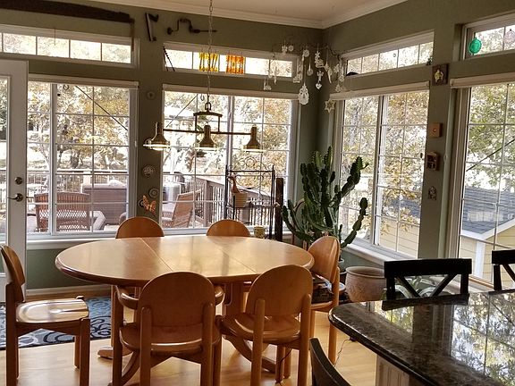 Breakfast area with large windows looking out onto the deck and into the yard