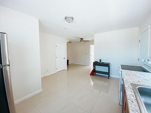 Open floor plan connecting kitchen, dinning, and living rooms