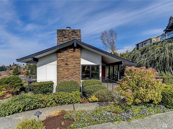 Front view of the home, walk down the path to the covered porch. Combined with the professionally maintained landscaping, the front door and entry are perfectly private from the street.