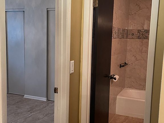 Hallway going to guest bedroom on left and guest bathroom straight ahead.