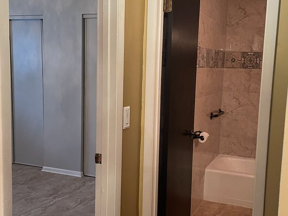 Hallway going to guest bedroom on left and guest bathroom straight ahead.