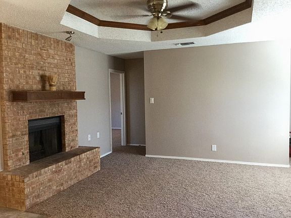 Living Room
						:
						Features a brick fireplace and ashtray ceiling with stained crown moulding.