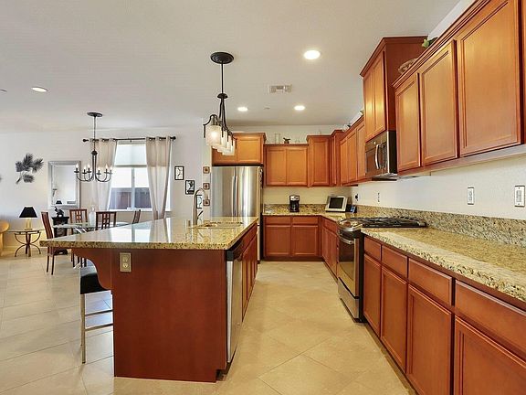 Chef's kitchen with tons of cinnamon maple cabinetry, beautiful granite counters and stainless steel appliances. The French Door refrigerator is included in the sale!