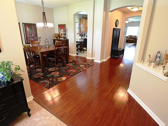 Inviting entrance with art niche and welcoming hardwood floors.