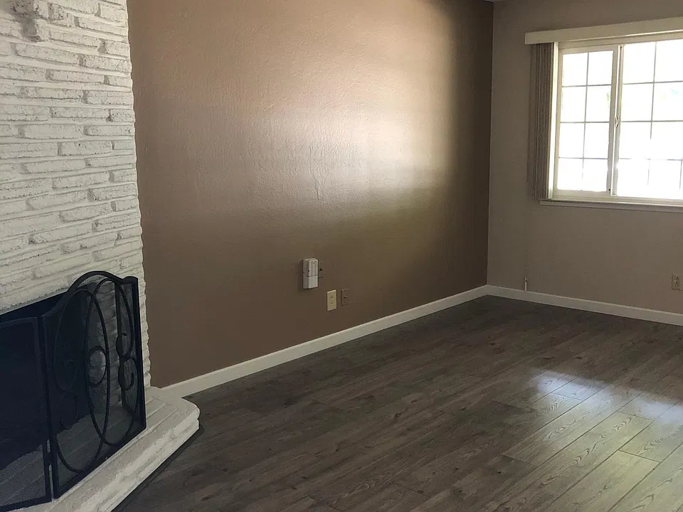 Living room with corner fireplace.