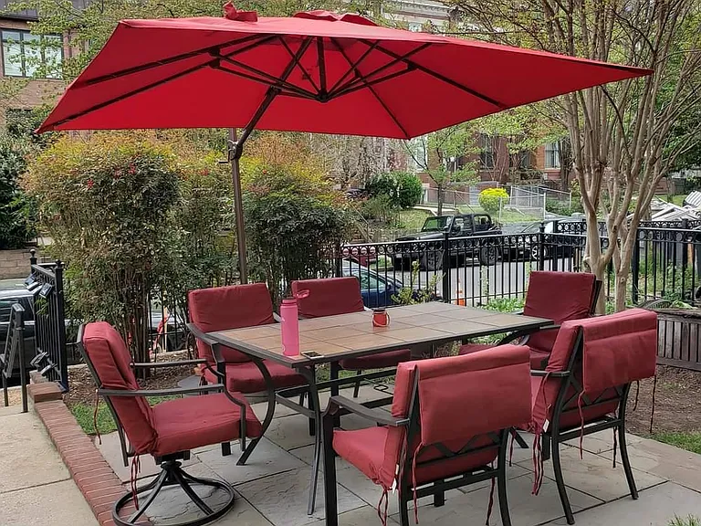 Communal table and umbrella in beautiful front yard. Fenced except entry stairs.