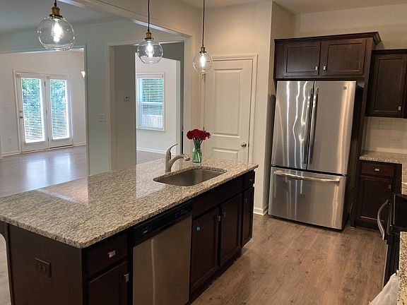 Kitchen opens to living room and dining room