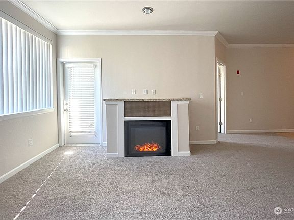 Warm & Inviting with a Cozy New Fireplace  This beautifully updated living room offers both style and comfort, featuring a brand-new fireplace that adds warmth and ambiance. Tall ceilings and fresh new flooring elevate the space, while abundant natural light creates a welcoming and sophisticated retreat.>