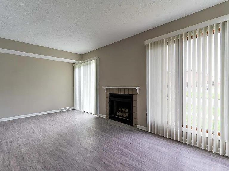 View of great room living area with fireplace and faux wood flooring
