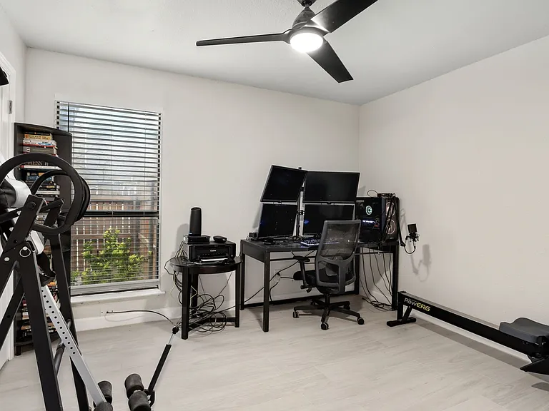 Office area featuring ceiling fan, a healthy amount of sunlight, and light hardwood / wood-style floors