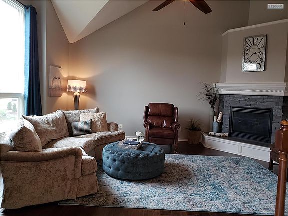 New stack stone on fireplace and hardwood floor in living room.