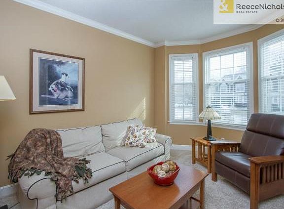 To the right of entry is a den or home office.