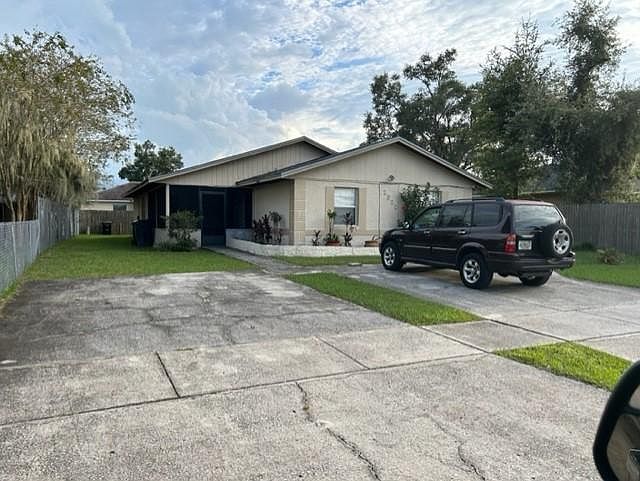 Front view of duplex with 2 car parking driveway for each apartment.