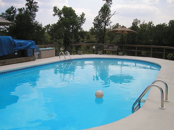 View of Pool, back yard and Lake from back of house