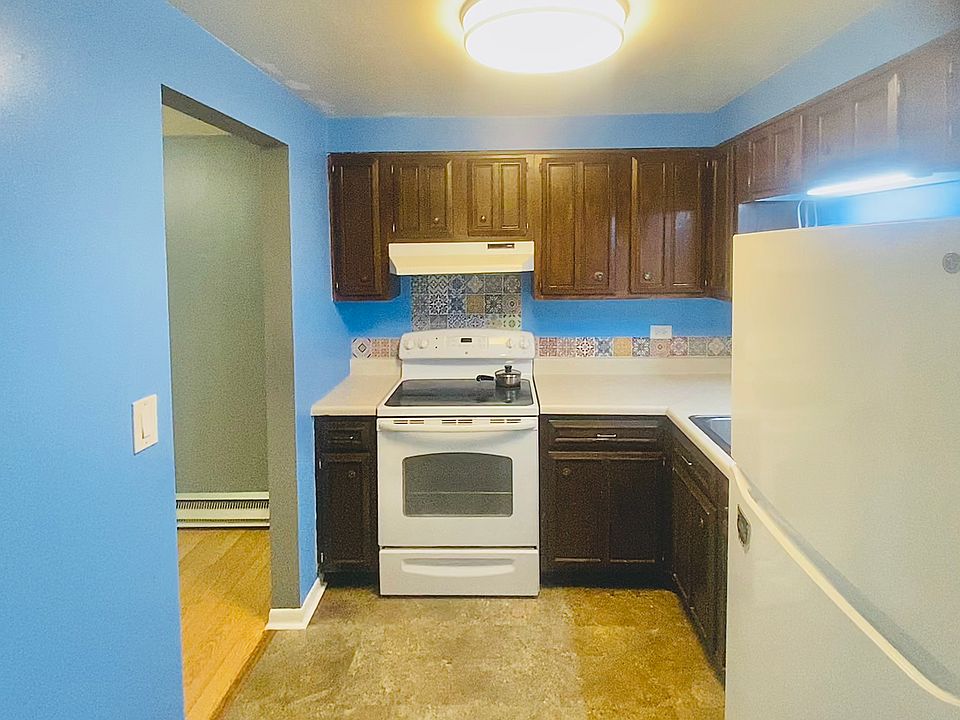 Kitchen features ample lighting, LED refrigerator, electric range with hood