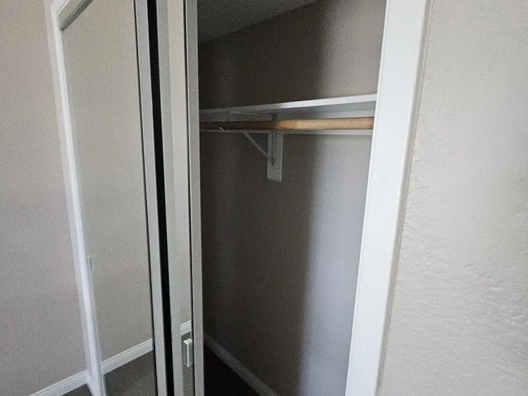 guest bedroom both have the same type closets